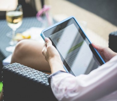 Girl using Tablet on the Garden